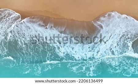 Similar – Luftaufnahme Panoramadrohne Blick auf den blauen Ozean Wellen, die am Sandstrand in Portugal erdrücken.