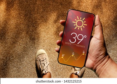 Ecology and Technology Concept. High Temperature Weather show on Mobile Screen on Hot Sunny Day. Top View, Grunge Dirty Concrete Floor with Sunlight as background