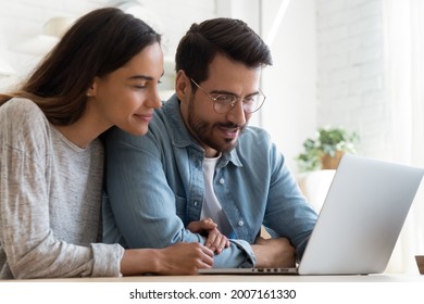 E-commerce Buyers, Online Comfort Easy Internet Retail Services Satisfied Users, Modern Tech Concept. Millennial Couple Looking At Laptop Screen Watch Video, Search Information, Read Commercial Offer