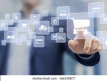 E-commerce concept with a person touching a button on a digital interface with icons of shopping cart, delivery truck and credit card, symbol of online purchase on internet - Shutterstock ID 566190877