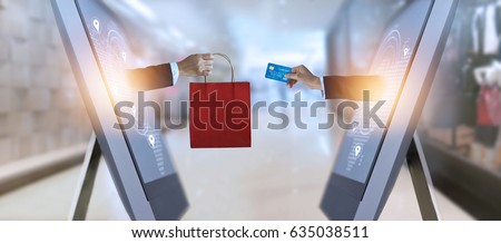 e-commerce, hand holding shopping bag and credit card from screen and global network, shopping and payments online concept, all on credit card are design up