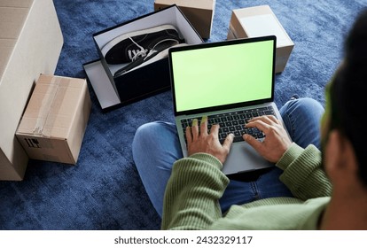 Ecommerce, man with laptop, green screen and boxes on floor, shoes and delivery service on digital app. Sale, discount and online shopping on fashion retail brand website, internet search on computer - Powered by Shutterstock