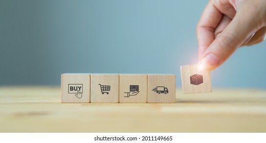 E-commerce Online Shopping Concept With Ecosystem. Customer's Hand Hold Wood Cube With E-commerce Icon, Package, Purchase, Payment, Delivery Car. The Symbol Of Online Purchase On Internet.  Copy Space