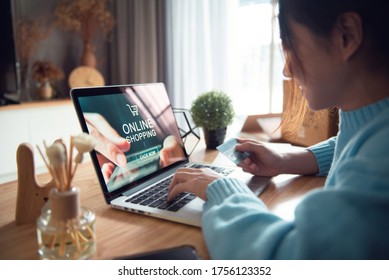 E-commerce And Online Shopping Concept, Woman Hand Using Laptop (Mockup Website) And Holding Credit Card For Shopping Payment Online At Home, Copy Space.