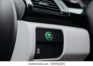 Econ mode button on dashboard in modern car. Eco mode, green button.