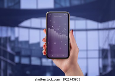 Economic analysis app concept with chart of the economic decline on smart phone in woman hand