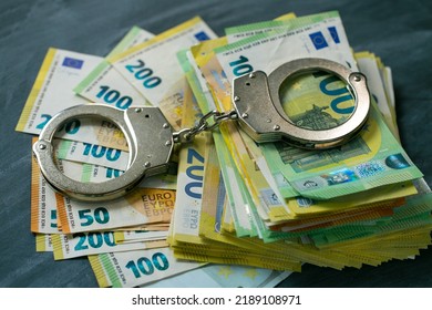 Economic Crimes.Arrest On Bank Accounts And Property In Europe. Corruption And Waste Of The Budget In The European Union.Handcuffs,euro Bills .Taking Bribes And Punishing Economic Crimes. 