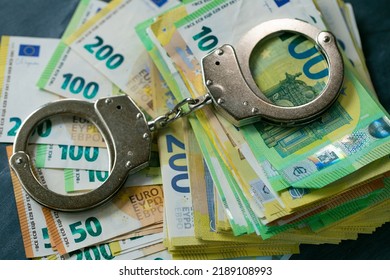 Economic Crimes.Handcuffs,euro Bills On Black Chalkboard Background.Arrest On Bank Accounts And Property In Europe. Corruption And Waste Of The Budget In The European Union.