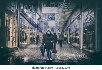 Economic Crisis Of 2020 , A Woman With A Mask Walk On A Shopping Mall During The Covid-19 Pandemic In Christmas Period In Casalecchio Di Reno, Italy, 6 Dec 2020