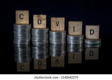 Economic Crisis, Covid Letters On Stacks Of Coins , Economic Impact Of The Corona Virus, Business Crisis And Financial Market Conditions Global Effects Of The Covid-19 Outbreak And Pandemia