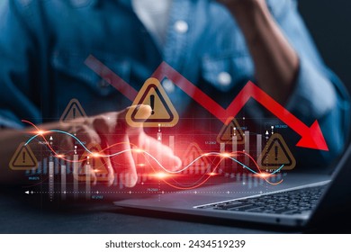 Economic crisis and global economic recession. Businessman use laptop analyze economic graph with warning sign for caution in investing economic situation warning, Business investment risks. - Powered by Shutterstock