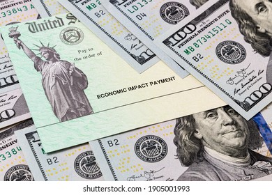 Economic Impact Stimulus Treasury Check And 100 Dollar Bills. Concept Of Aid, Relief And Unemployment Insurance Payment During Covid-19 Coronavirus Pandemic