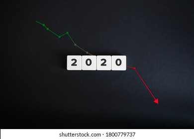 Economic Recession And Downfall In Year 2020. Down Arrow Chart. Block Letters On The Black Paper Background. World Economy Depression Banner And GDP Drop.