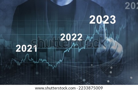 economic recovery after falling due to inflation, stagnation, recession, 2023 financial chart. Businessman pointing graph of future growth on dark blue background
