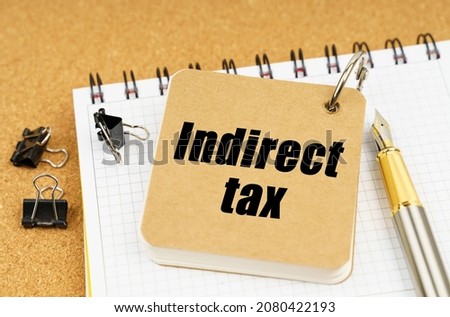 Economy and business concept. On the table is a pen and a notebook with the inscription - Indirect tax