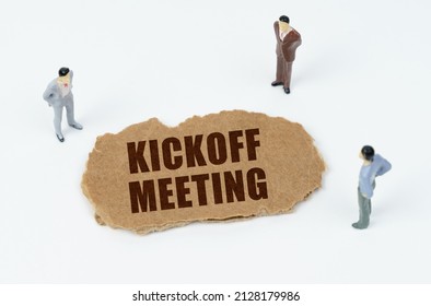 Economy And Business Concept. On A White Background, Figures Of Businessmen And Torn Cardboard With The Inscription - Kickoff Meeting