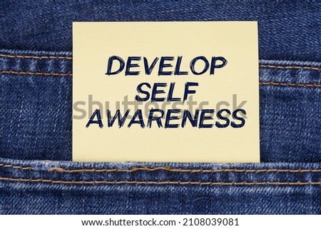 Economy and education concept. There is a paper sticking out of a jeans pocket with the inscription - Develop Self Awareness Stock photo © 