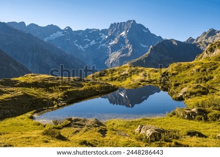 Ecrins National Park and Lauzon Lake in summer with a view of the Sirac mountain peak. The lake is a well known hiking site (GR 54 trek) in the French Alps. Gioberney, Valgaudemar, Alps, France