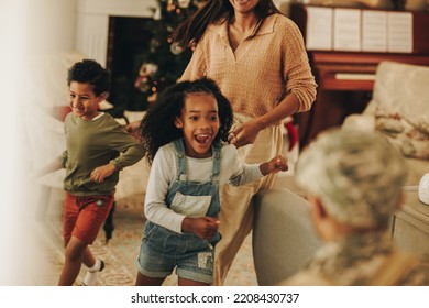 Ecstatic Children Running To Welcome Their Father Upon His Return From The Army. American Soldier Reuniting With His Wife And Kids After Serving In The Military. Serviceman Coming Back Home.