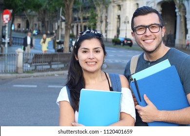 Ecstatic couple of ethnic international students abroad - Shutterstock ID 1120401659