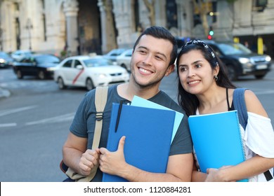 Ecstatic couple of ethnic international students abroad - Shutterstock ID 1120884281