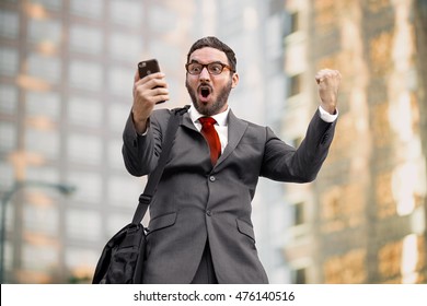 Ecstatic Happy Executive Sales Businessman Cheering Excited In Celebration After Good News