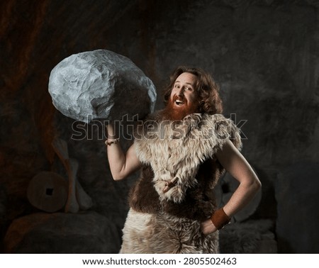 An ecstatic prehistoric man with a red beard and fur clothing effortlessly lifts a massive boulder above his shoulder with a single hand. With a triumphant smile and a confident pose, he humorously parodies superhuman strength, bodybuilding, and the completion of a heavy task in a Stone Age setting.