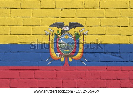 Ecuador flag depicted in paint colors on old brick wall. Textured banner on big brick wall masonry background