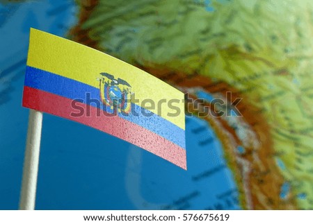 Ecuadorean flag with a globe map as a background macro
