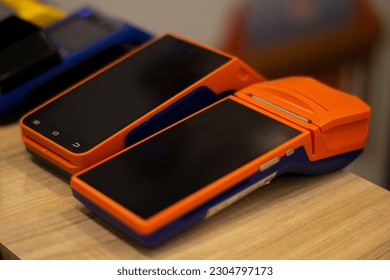 EDC or Electronic Data Capture Machine on wooden table