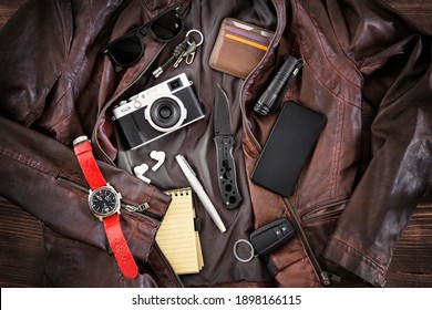 EDC or Every Day Carry items laid out on leather jacket