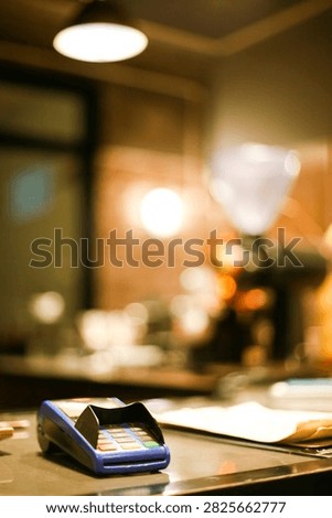 EDC machine with menu book at coffee shop cashier desk. Selective focus. Copy space