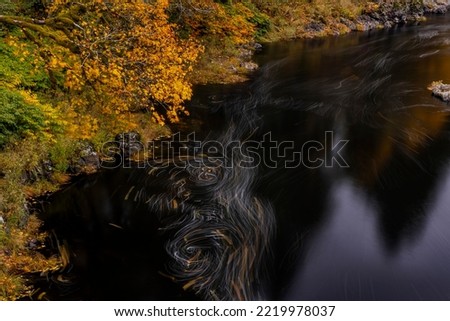 Eddy forms swirling patterns in the Nehalem River in autumn in the Tillamook State Forest, Oregon, USA