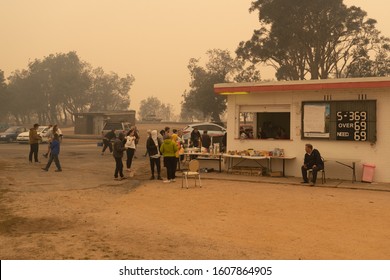 Eden, Australia - December 31, 2019: Evacuees At The Eden Evacuation Center Are Being Given Food And Water By Volunteers At The Sports Oval As It Is Shrouded In Thick Bushfire Haze.