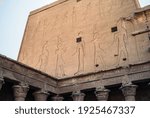 Edfu Temple - Northern Facade of the East Wing of the Great Pylon with Reliefs of King Ptolemy XII interacting with the Gods Horus and Hathor