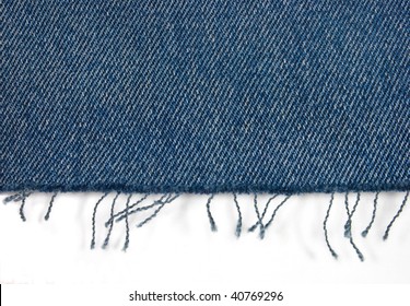 Edge Of Blue Jeans Fabric With Fringe On White