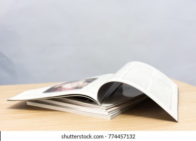 edge book on the wooden table.  
Stack magazines on white background.    
school education concept.
(selective focus ) - Powered by Shutterstock