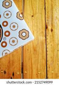 The Edge Of Donut Box On A Wooden Table.