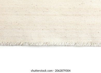 Edge of fabric canvas texture on white background.