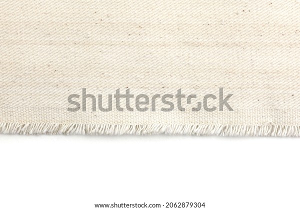 Edge of\
fabric canvas texture on white\
background.