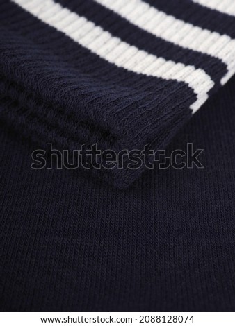 the edge of multi-colored socks, curved sleeves, several layers of fabric.