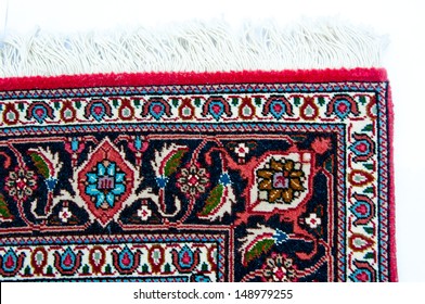 The Edge Of A Persian Rug Is Shown In Close Up.