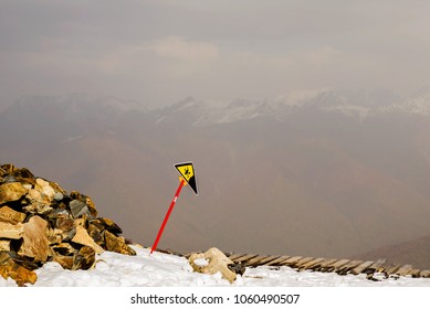 The edge of the precipice with a warning