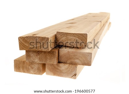 Edge of six cedar two by four wood boards on white background