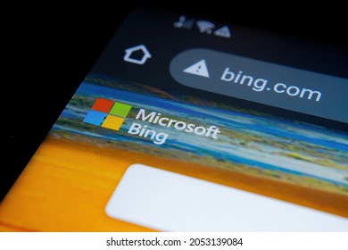 Edge of smartphone with Microsoft BING search engine website in Google Chrome browser seen on screen. Selective focus. Stafford, United Kingdom, October 3, 2021.