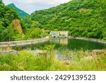 At the edge of water reservoir on river Vacha Daily equalizer of hydroelectric power station-VEC "Vacha in Southern Bulgaria, Phodope mountains Bulgaria.July 11th 2014