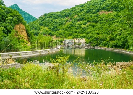 At the edge of water reservoir on river Vacha Daily equalizer of hydroelectric power station-VEC 