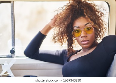 edgy african american model posing in vintage vehicle interior - Powered by Shutterstock