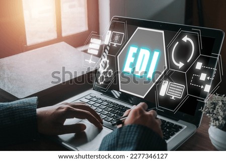 EDI, electronic data interchange concept, Person using computer on office desk with virtual screen electronic data interchange icon.