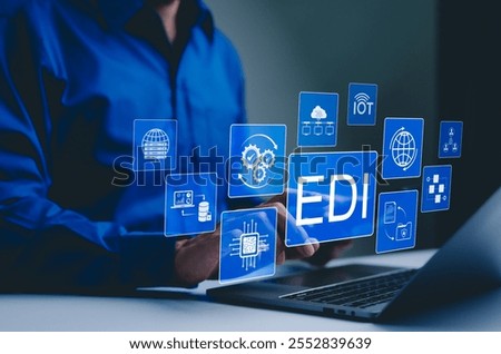 EDI, Electronic Data Interchange Concept. Businessman working on EDI (Electronic Data Interchange) icons, global data transfer, digital security, information paperwork exchange in business context,